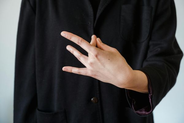 Close-up of a woman's hands in a meditative mudra gesture.